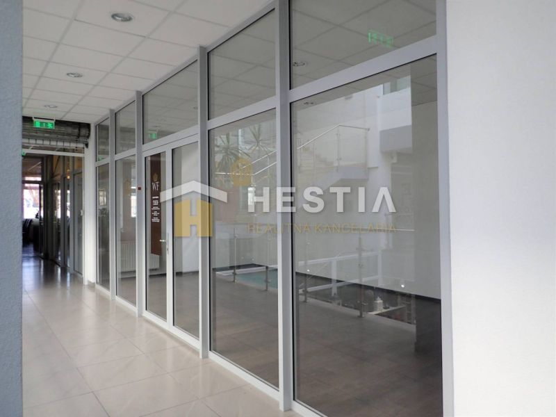 Glass partitions and white tiles in the interior of a 2-room apartment.
