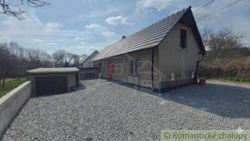 A family house in Sobotište with a concrete courtyard and an adjacent garage.