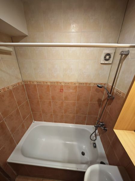A bathroom with a bathtub and tiles in a 3-room apartment, a decent space for relaxation.