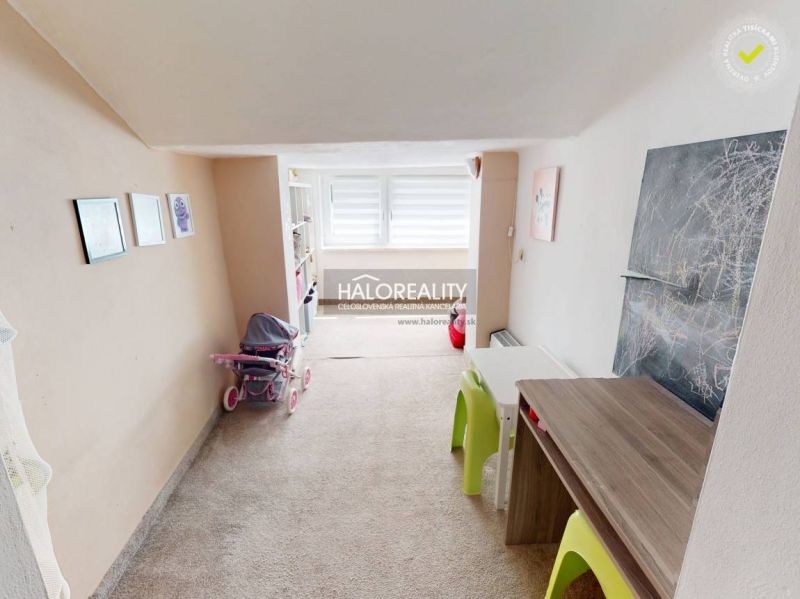 Children's room in a family house with carpet, furniture, and children's drawings.
