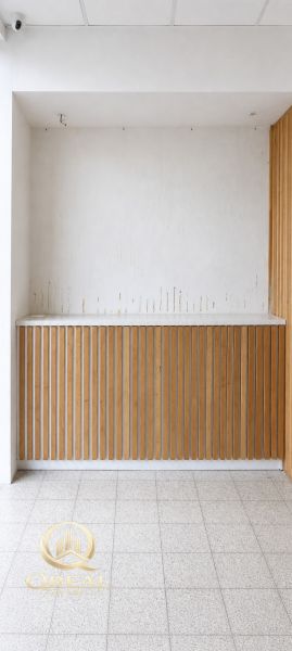 Commercial spaces with white walls and wooden decor, tiled floor.