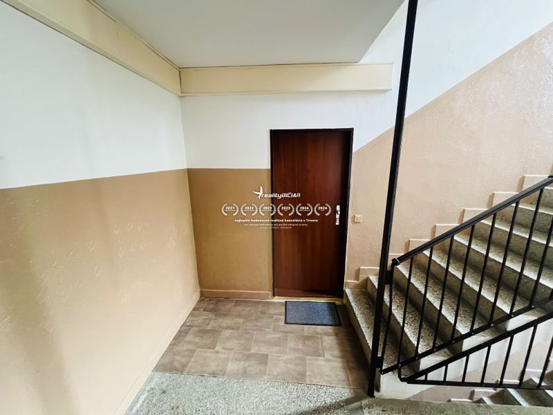 Entrance door to a 3-room apartment, staircase, and walls with pastel shades.