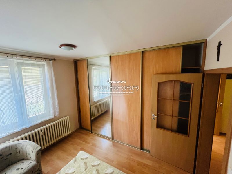 White wall, wardrobe with sliding doors, wooden decor flooring, 3-room apartment.