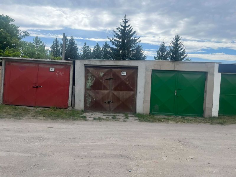 Garages on Gúgska Street in Nové Zámky with colorful doors and surrounding vegetation.