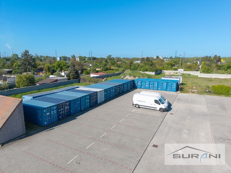 Parking lot with a van and containers in Bratislava - Podunajské Biskupice on Svornosti Street.