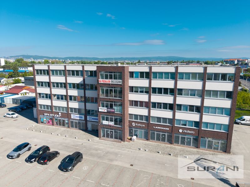 Offices on Svornosti in Bratislava - Podunajské Biskupice with a parking lot and cars.