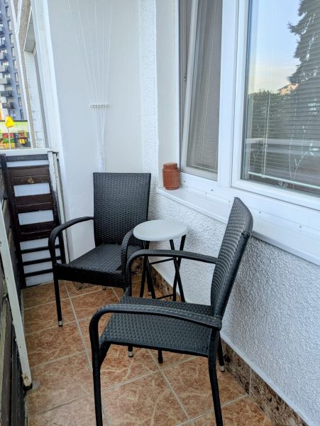 A balcony in Dubnica nad Váhom on Centrum I with two chairs and a table.