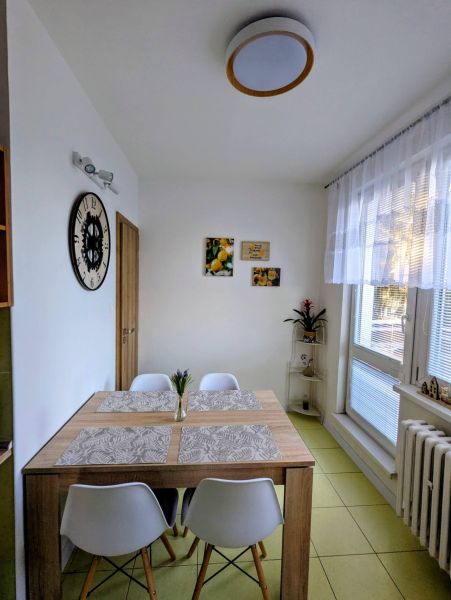 Dining room in a 2-room apartment with a dining table and decorations.