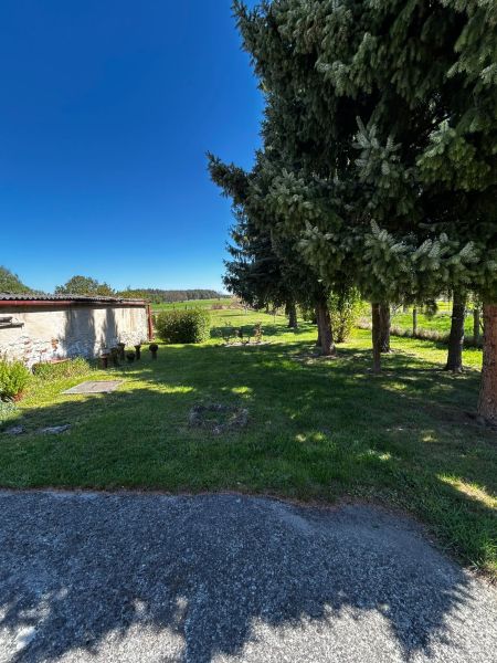 The garden at the family house on Mikulášov in Lakšárska Nová Ves with large trees.