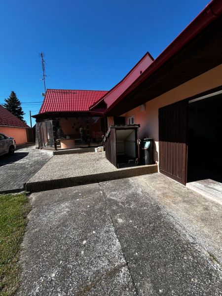 A family house in Mikulášov in Lakšárska Nová Ves with a red roof and a yard.