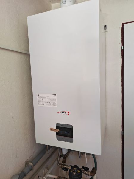 A wall-mounted gas boiler Protherm in the utility room of a family house.