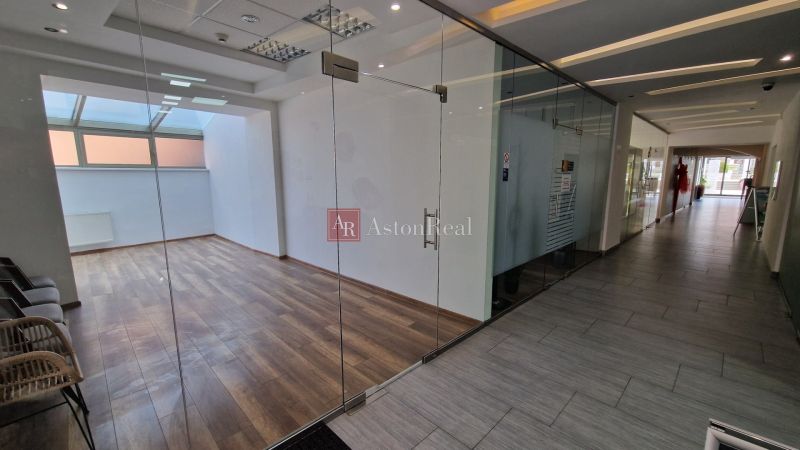 Glass doors, room with wood-patterned flooring, commercial premises.