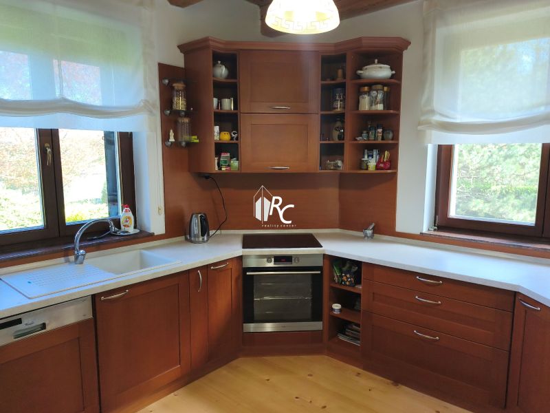 A kitchen with wooden decor and a countertop in a family house.