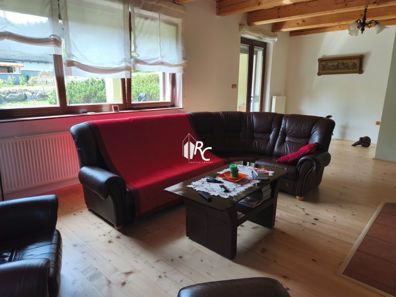 Living room in a family house with leather sofas and a wooden decor floor.