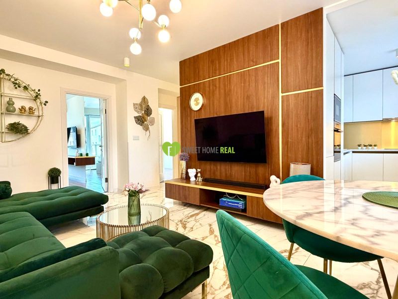 A living room in a 3-room apartment with a marble floor and green sofas.