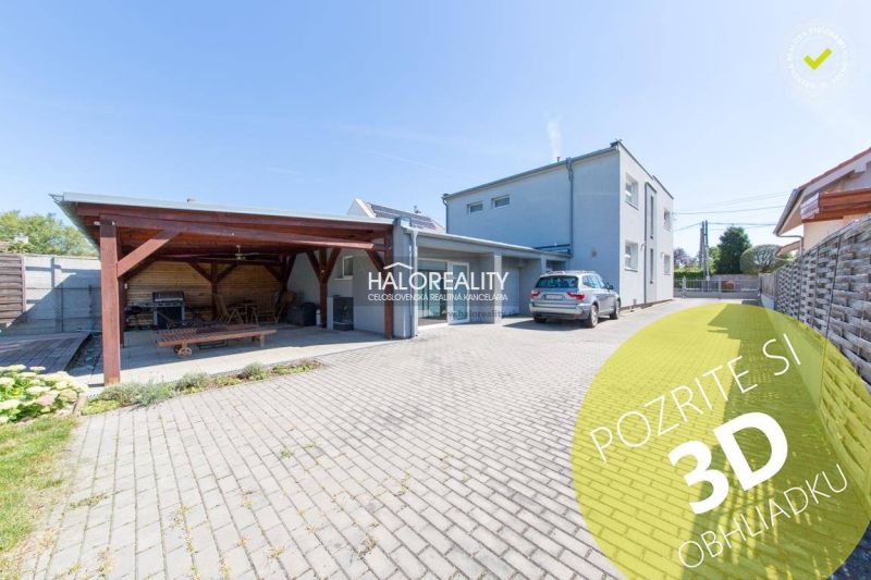A family house in Vrakuňa with a carport and a landscaped garden.