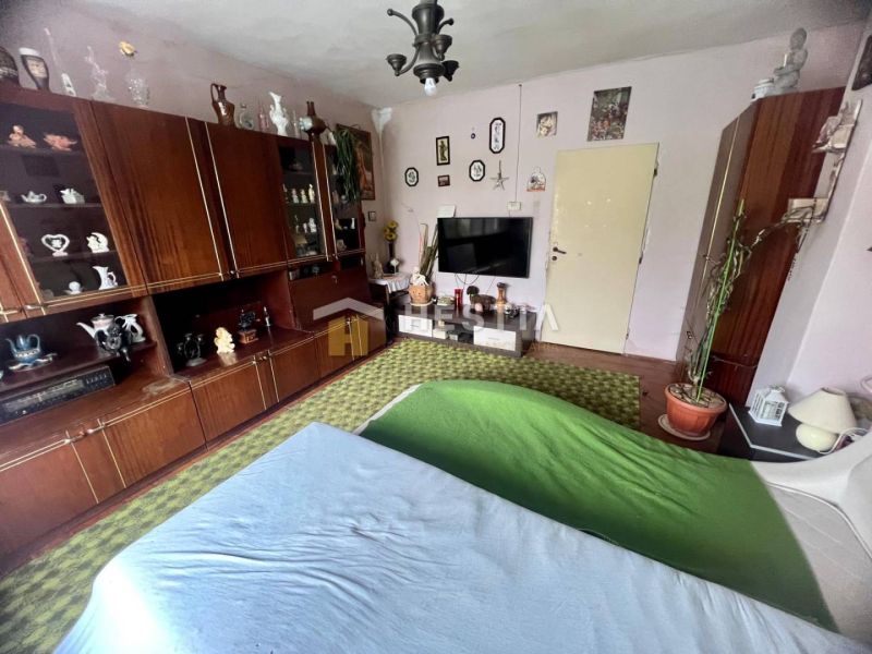 A living room in a family house with antique furniture and decorations, a floor with a wooden decor.