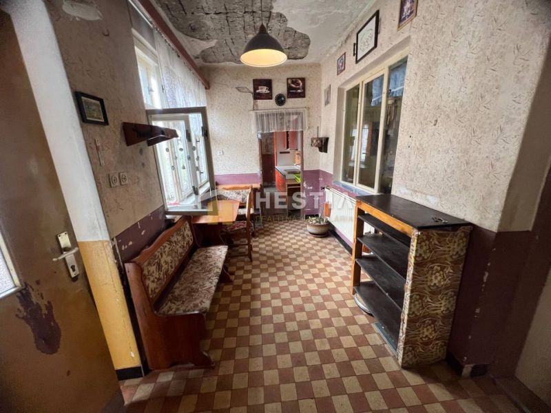 The interior of a family house with retro furniture and checkered flooring.