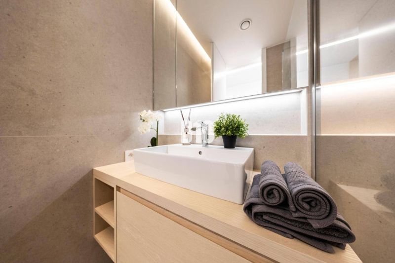 Bathroom with a modern sink, towels, and decoration in a 3-room apartment.