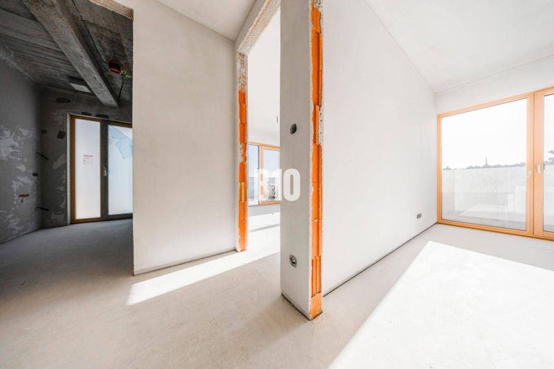 Interior of a 3-room apartment with large windows and a concrete ceiling.