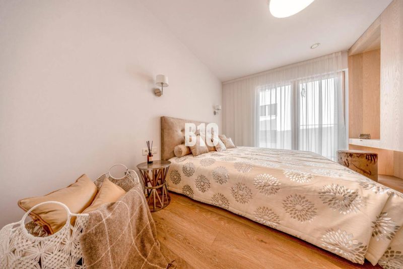 A bedroom in a 3-room apartment with a bed and a floor with a wooden decor.