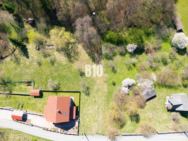 Aerial view of properties - residential area with family houses and greenery on Obrancov Mieru Street in Banská Štiavnica.