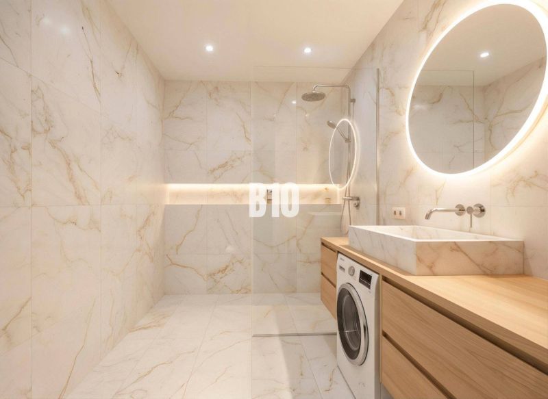 Bathroom in a 4-room apartment with a large shower, washing machine, and backlit mirror.