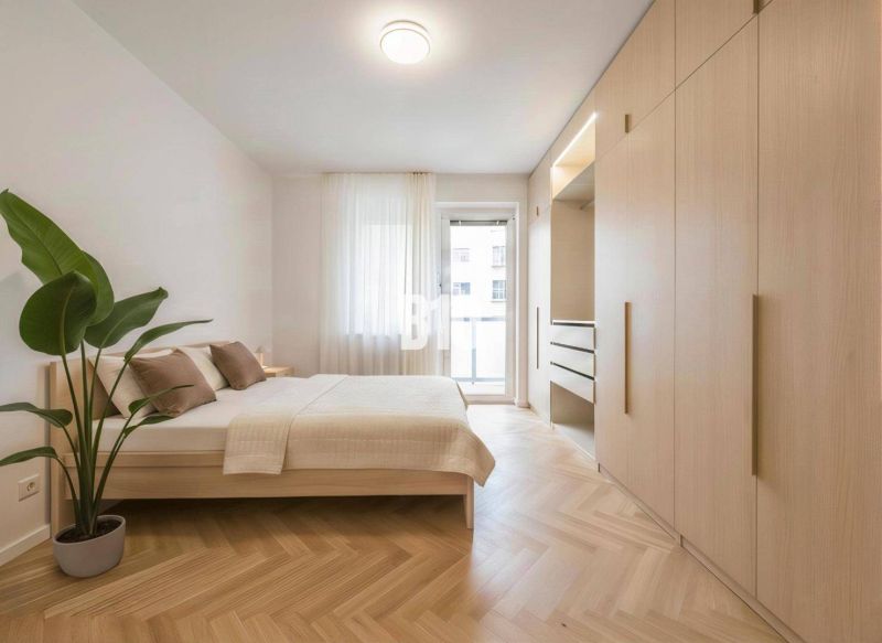 Bedroom in a 4-room apartment with a large wardrobe and a wooden decor floor.