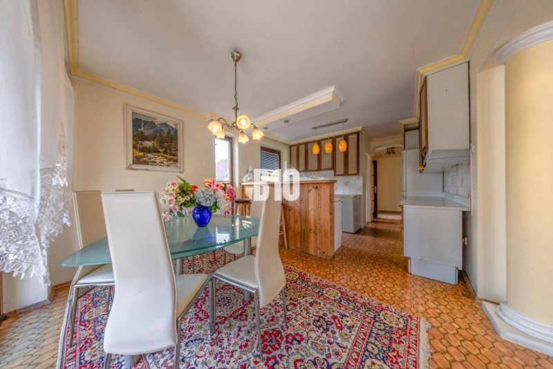 Dining area with flowers on the table in the kitchen of a family house.