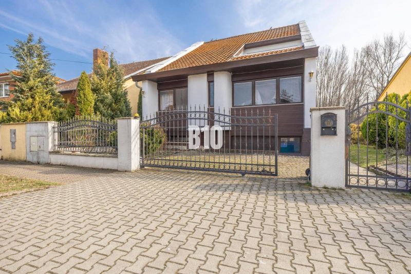 A family house on Dunajská Street in Hamuliakovo with a metal gate and a garden.