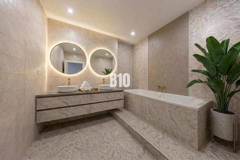 Elegant bathroom with a bathtub, double sink, and large mirrors in a 3-room apartment.