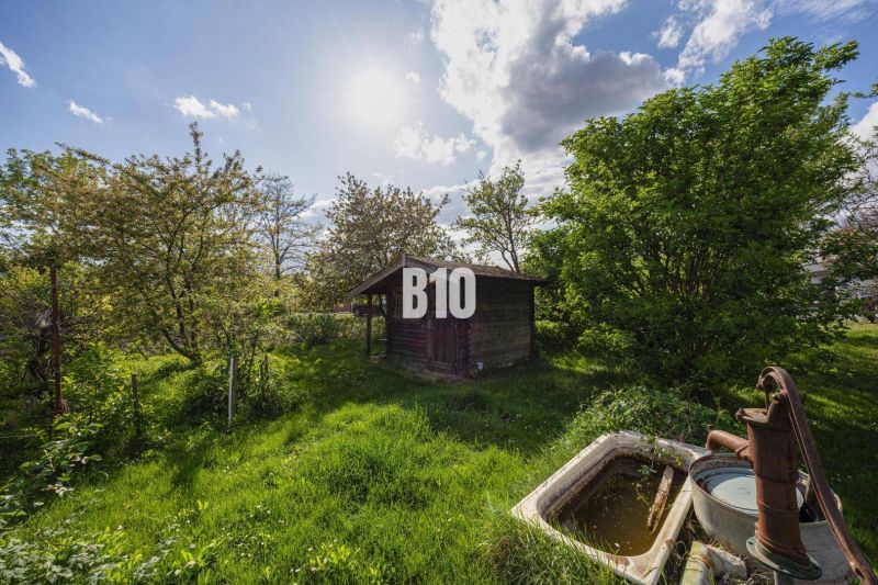 Garden with a wooden structure on a residential plot in Dunajská Lužná.