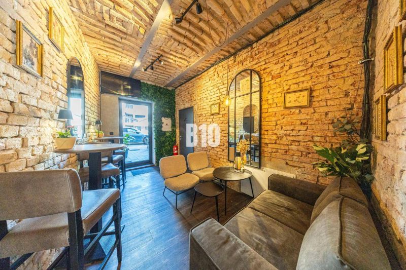 Industrial interior style with brick walls and wood-patterned flooring in dining areas.