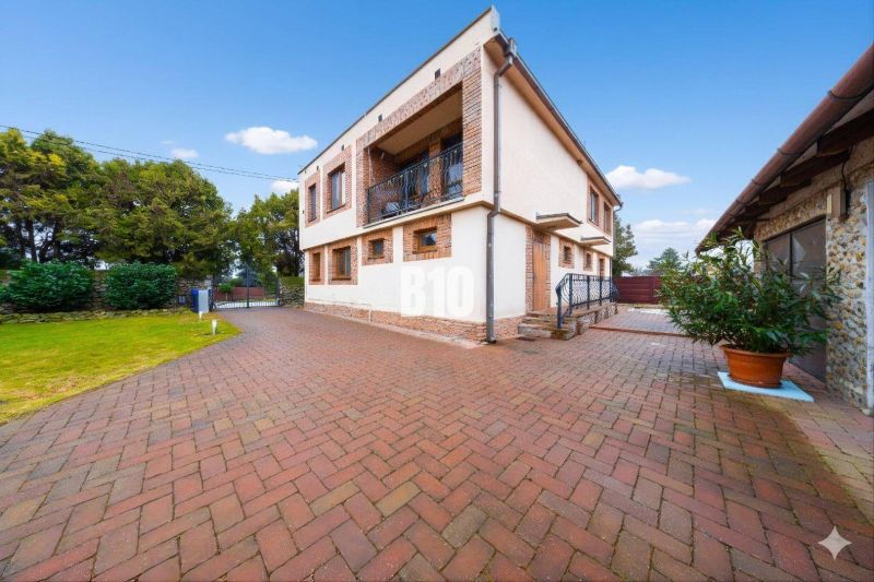 A family house in Štvrtok na Ostrove with a spacious yard and garden, brick design.