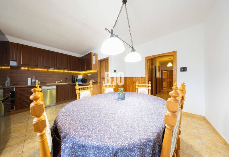 A dining room in a family house with wooden decor and a decorated table.