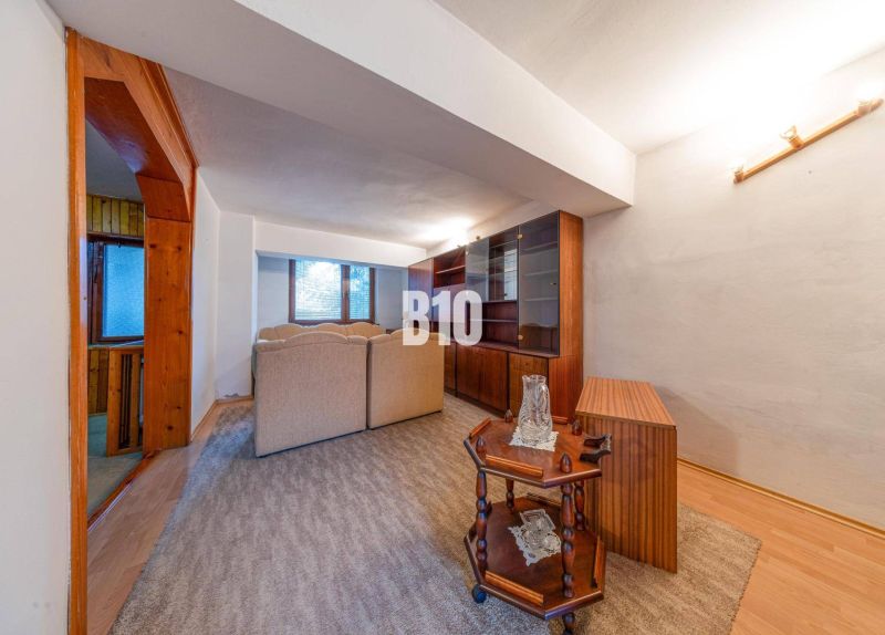Living room in a family house with a perspective of wooden furniture and comfortable seating sets.