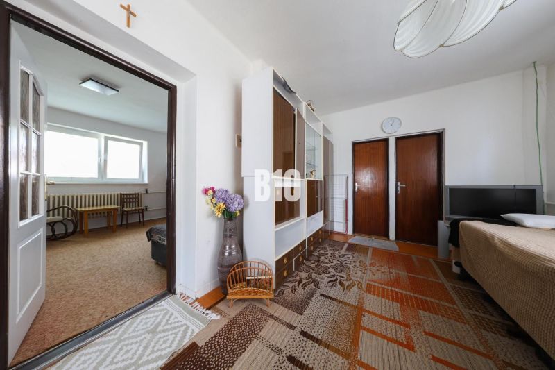 Living room in a family house with furniture and a carpet.
