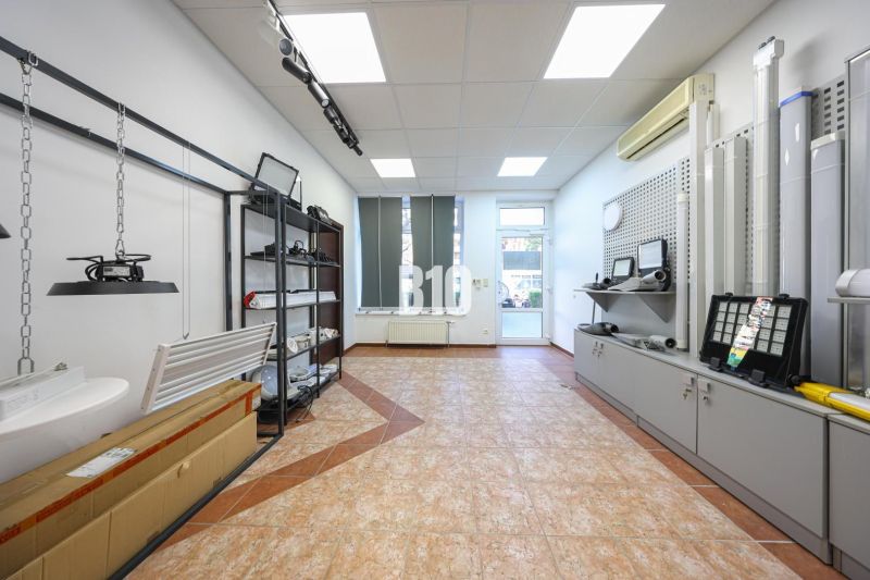 Commercial premises with displayed lighting products and ceramic flooring.