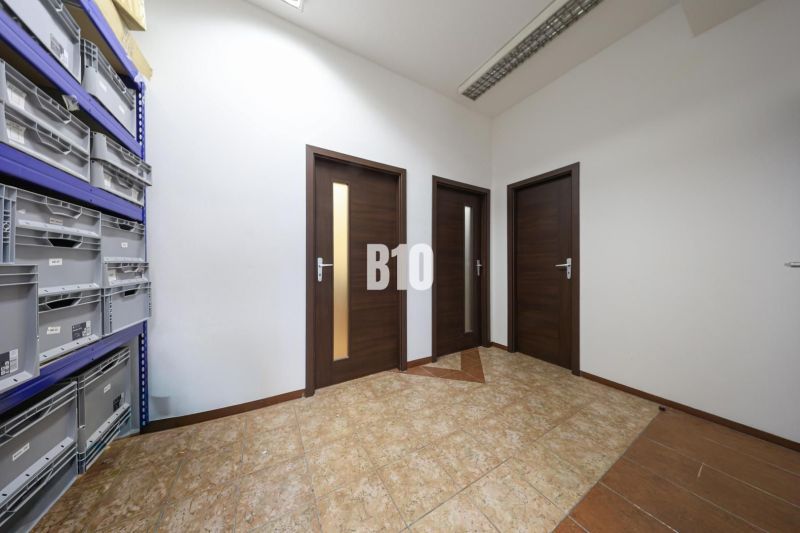 Commercial premises with ceramic flooring and shelves for storage boxes.