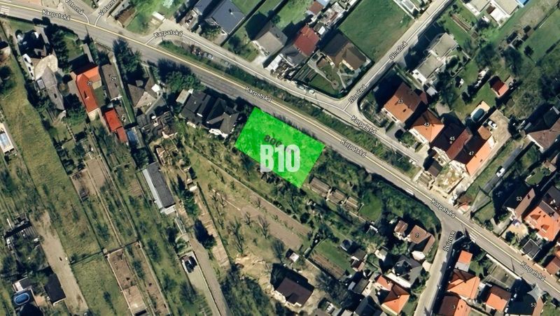 Aerial view of residential plots in Marianka, including buildings and road network.