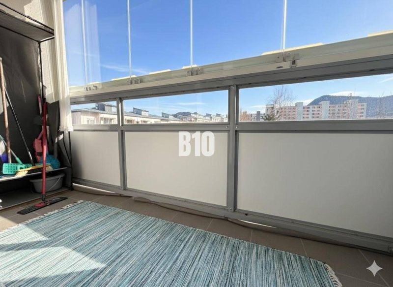 The balcony of a 3-room apartment in Ružomberok with a view of the city and mountains.