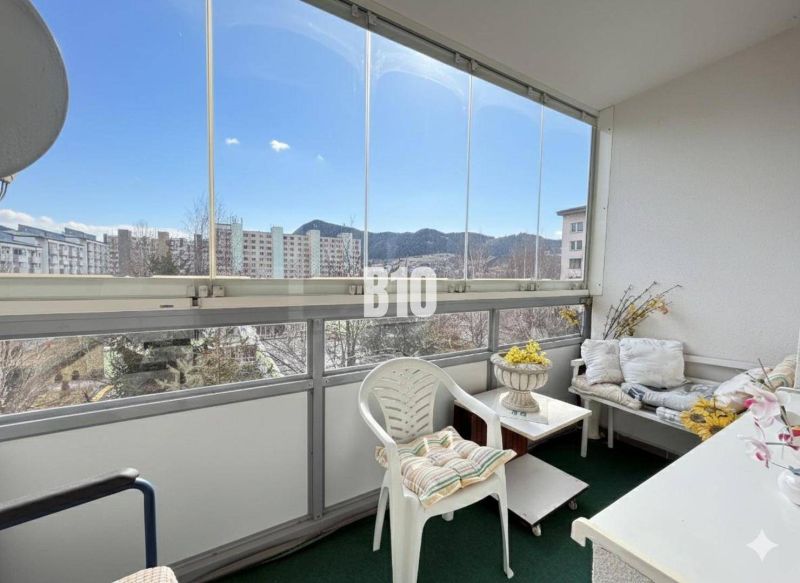 A furnished balcony in a 3-room apartment with a view of Ružomberok and the apartment blocks.