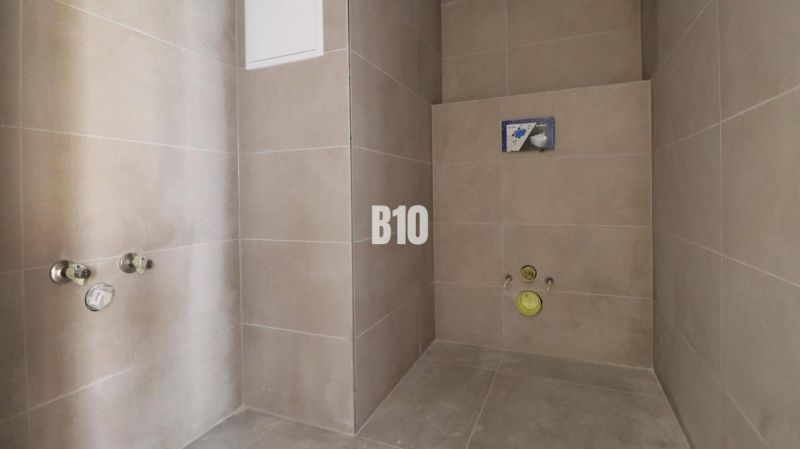 Floor tiling and preparation for sanitary installation in offices.