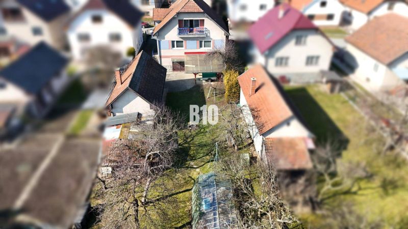 A family house in Turany with a yard, garden, and surrounding houses.