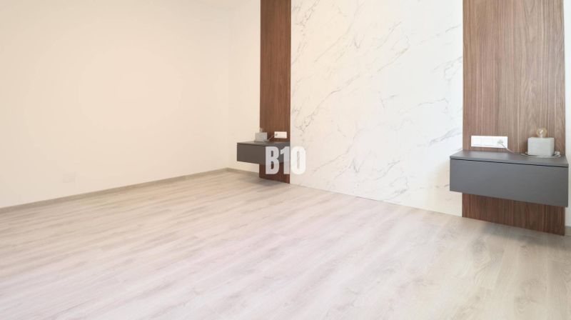 Interior of a 2-room apartment with a wooden decor floor and a decorative wall.
