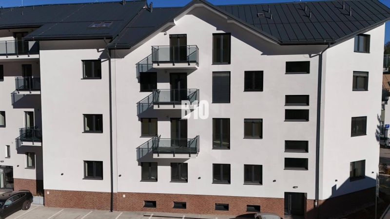 Apartment building in Dolný Kubín with parking spaces and balconies.