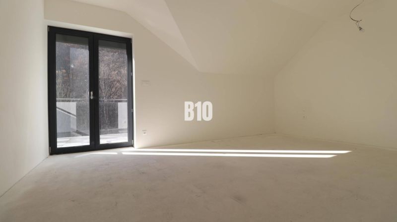 A bright room in a 3-room apartment with large glass doors.