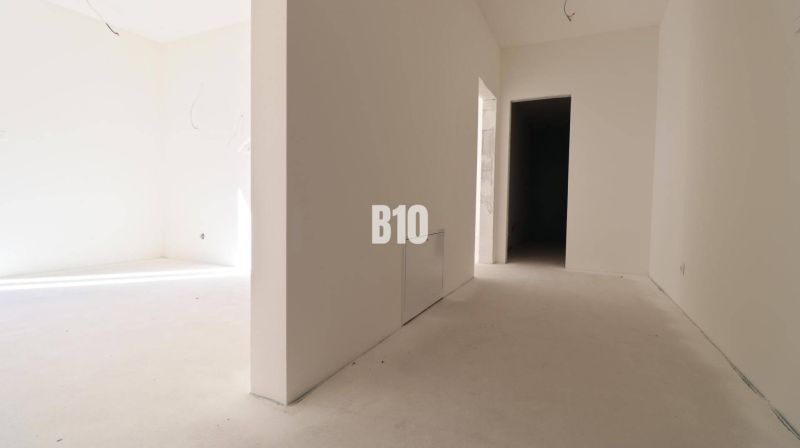 A bright hallway with white walls in a 3-room apartment.