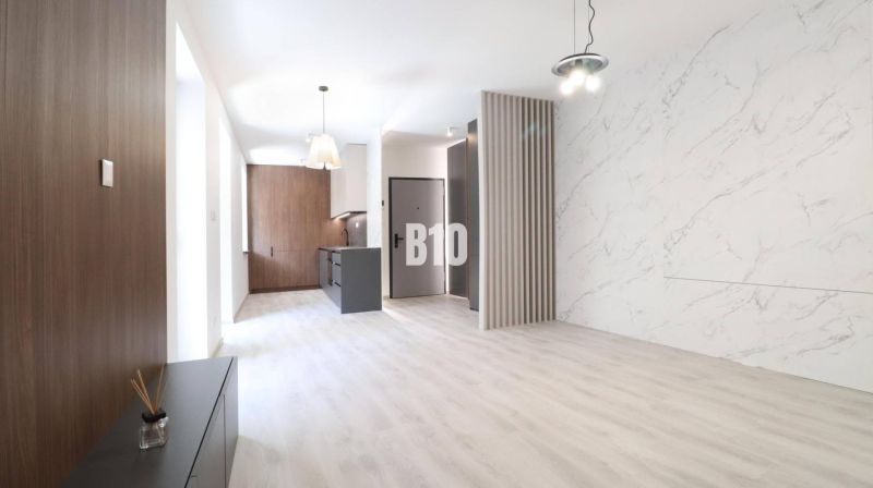 Interior of a 2-room apartment with a wooden decor floor and marble cladding.