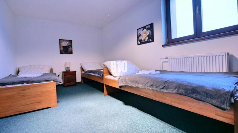 A bedroom with three beds and placed decorations in a 3-room apartment.